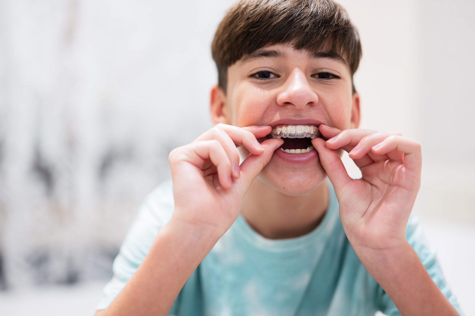 teen inserting invisalign tray